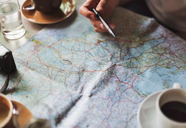 Planing out future travels on a map. Traveling is one of my favorite New Years resolution ideas.