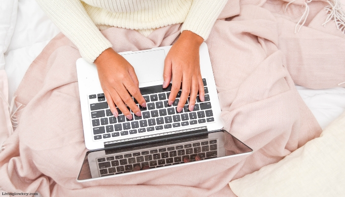 woman typing on a computer trying to figure out her personal finances.