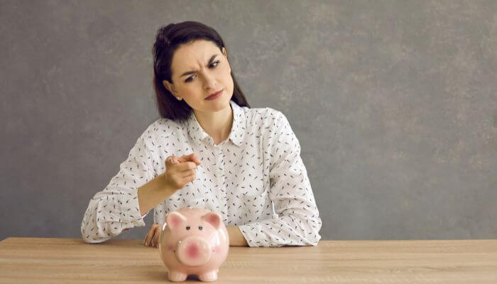 lady looking at her piggy bank