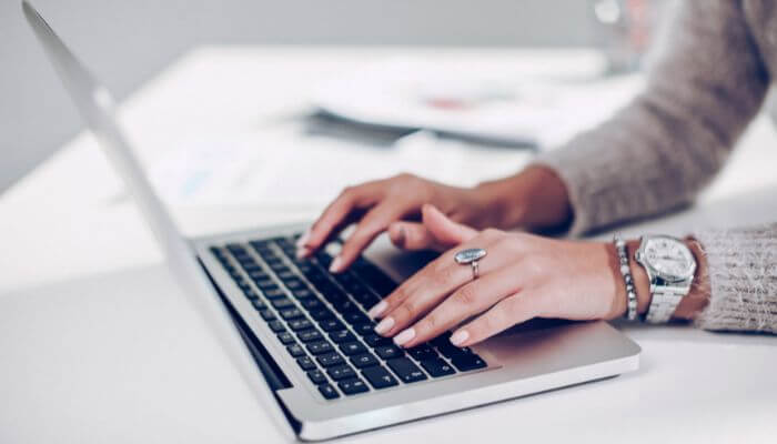 women typing on computer