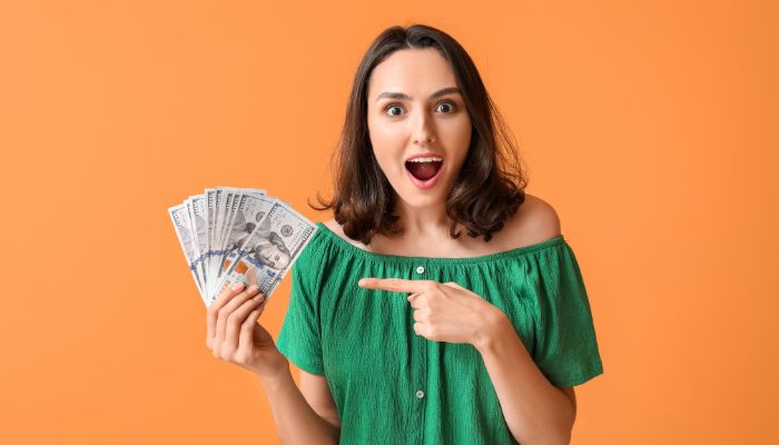 girl holding 2000 dollars