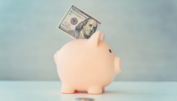 saving money in piggy bank for emergency fund